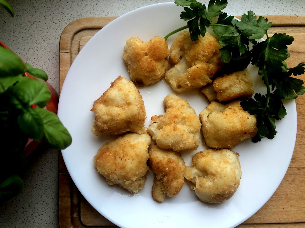 Fried cauliflower served on the plate with parsley greens.