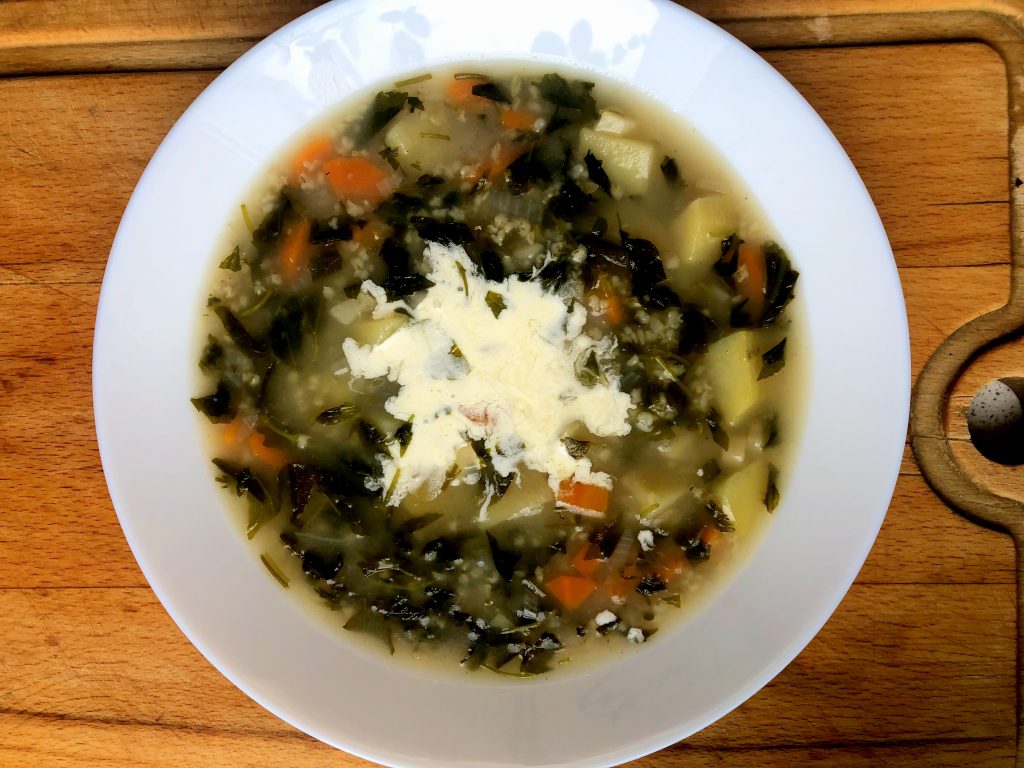 Goosefoot soup served on the plate with sweet cream