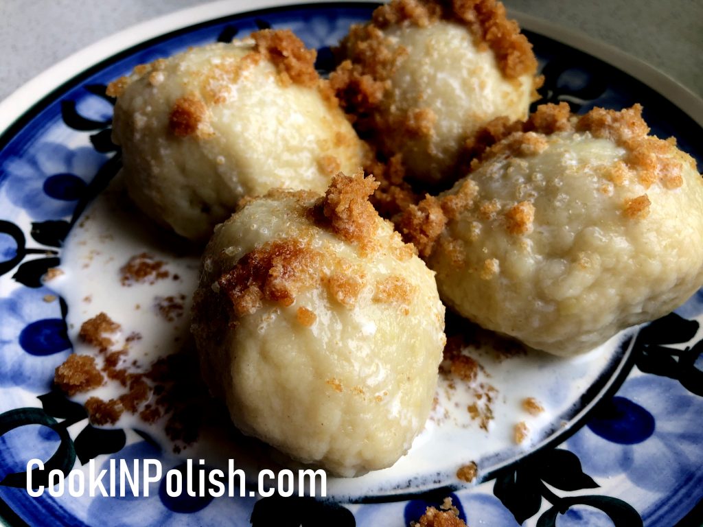 Polish Plum knedle served on the plate with breadcrumbs and sweet cream