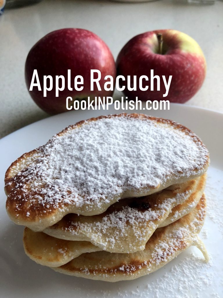 Apple racuchy served with powdered sugar and apples.