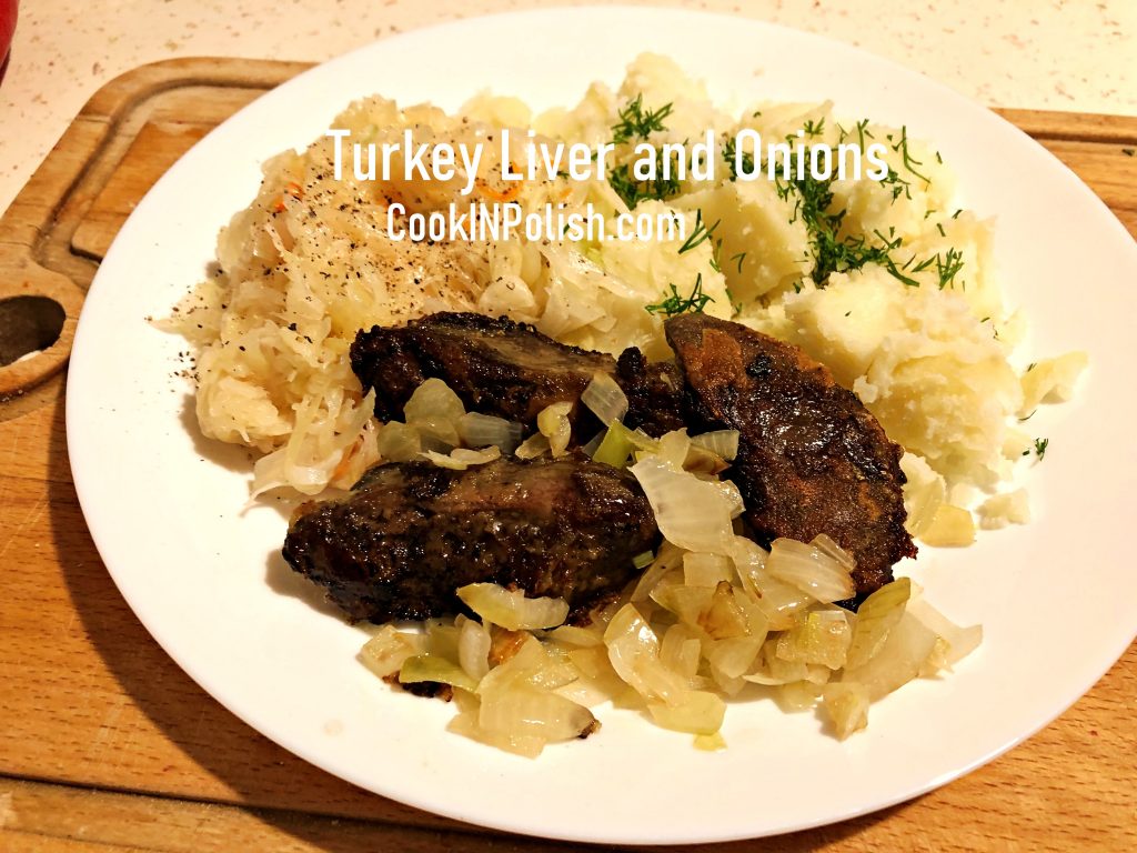 Turkey liver and onions served on the plate with sauerkraut and mashed potatoes