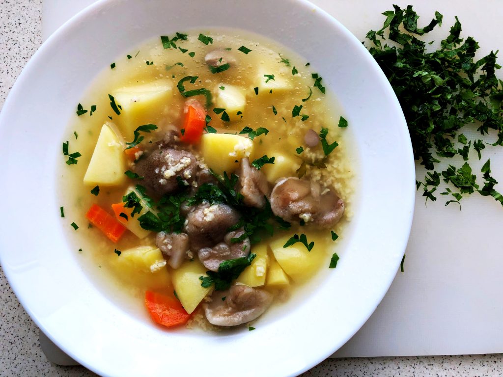 Traditional Polish Soup: Polish mushroom Barley Soup served on a plate.