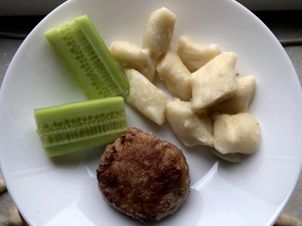 Polish Kotlety Mielone served with kopytka and cucumber