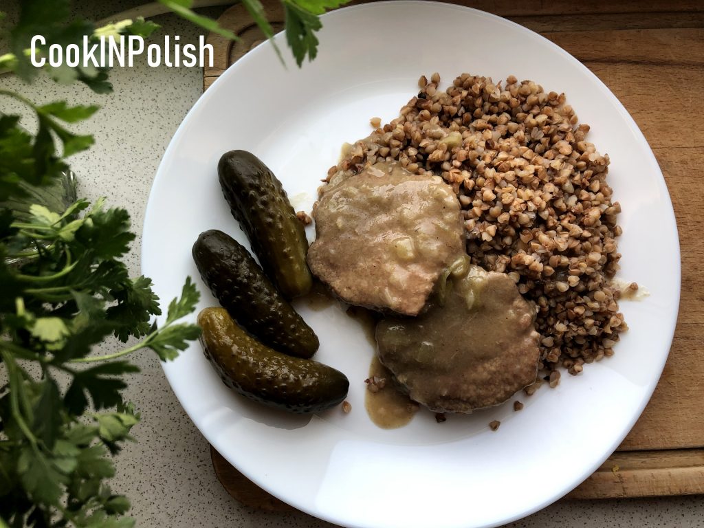 Beef Cutlets with Buckwheat served with pickle cucumber on the plate.