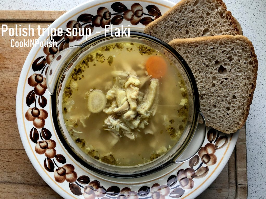 Polish Tripe Soup Flaki, served on the plate with rye bread.