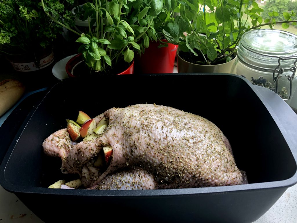 Stuffed duck with apples in a baking dish