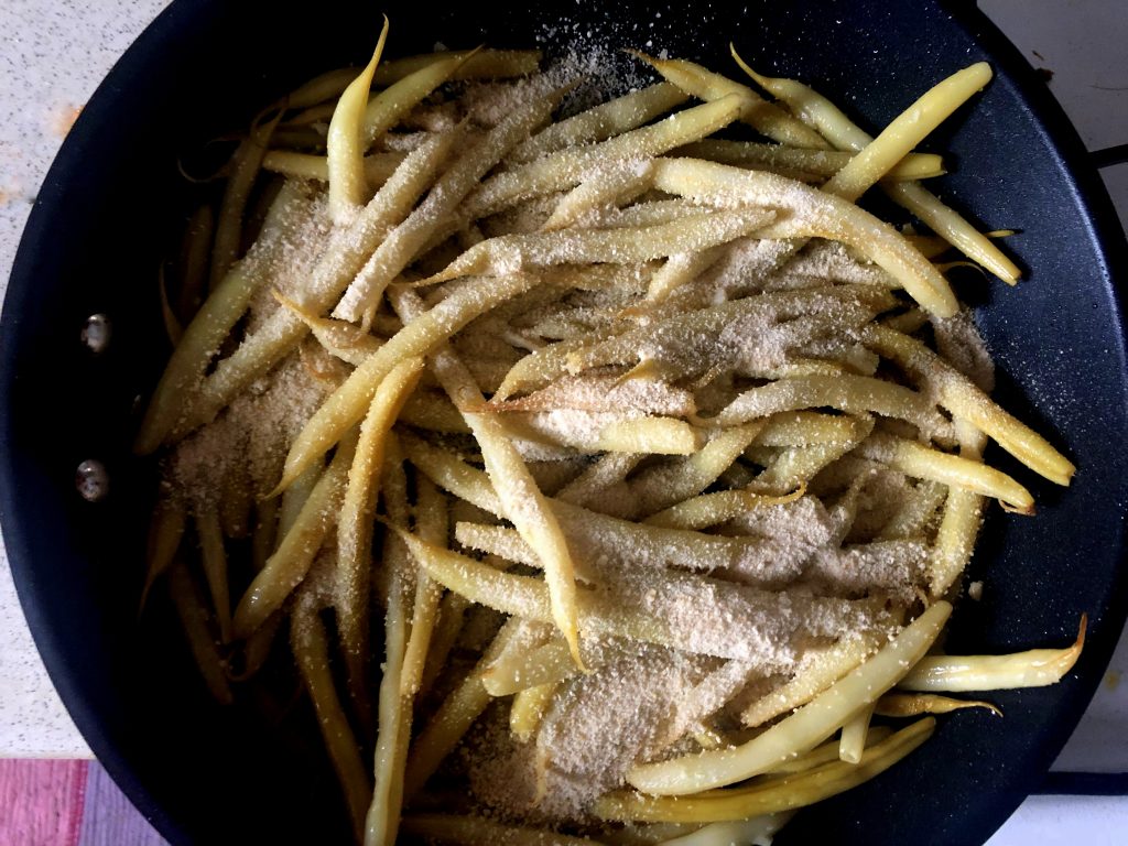 String beans on the frying pan with breadcrumbs