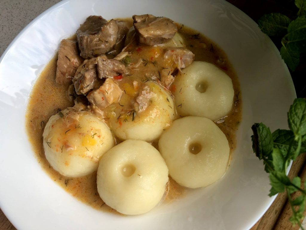 Polish Pork Stew with Silesian Potato Dumplings served on the plate.