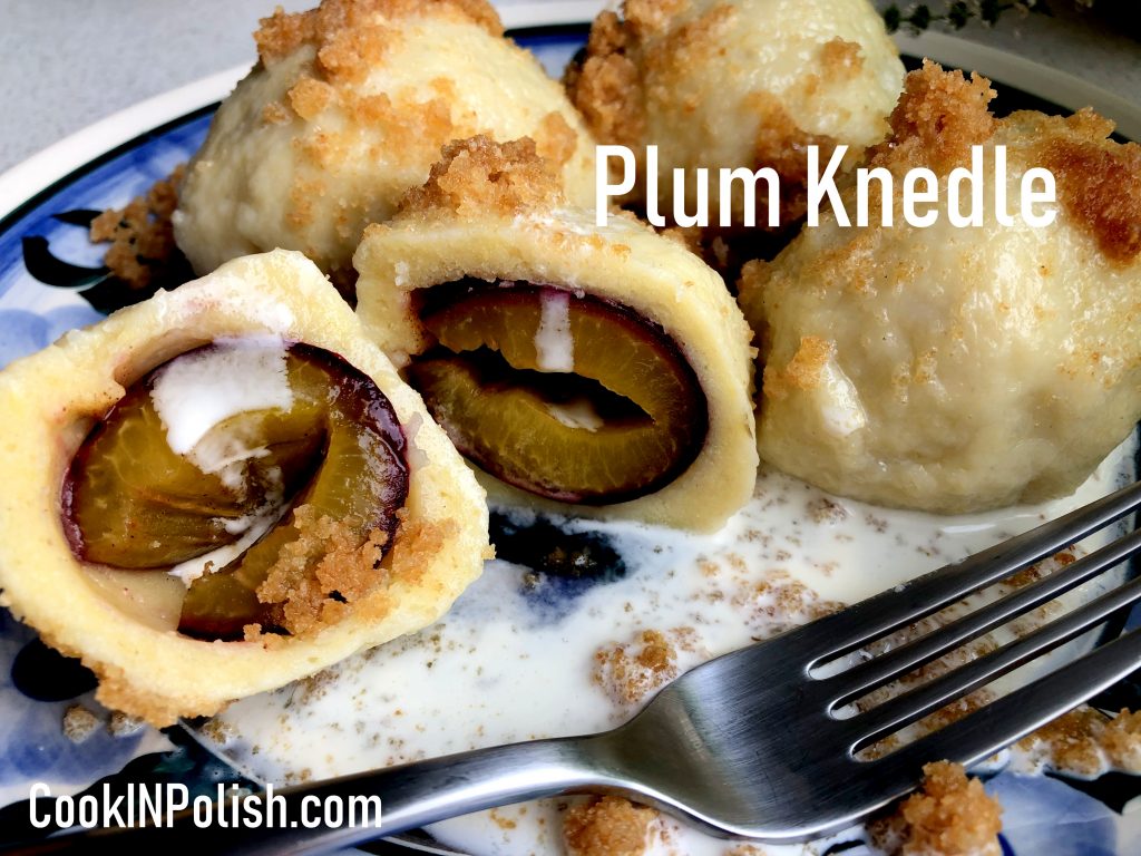 Polish Plum knedle served on the plate with breadcrumbs and sweet cream