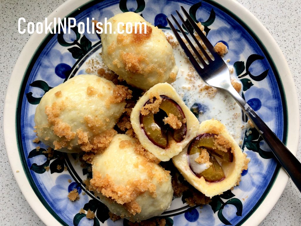 Polish Plum knedle served on the plate with breadcrumbs and sweet cream