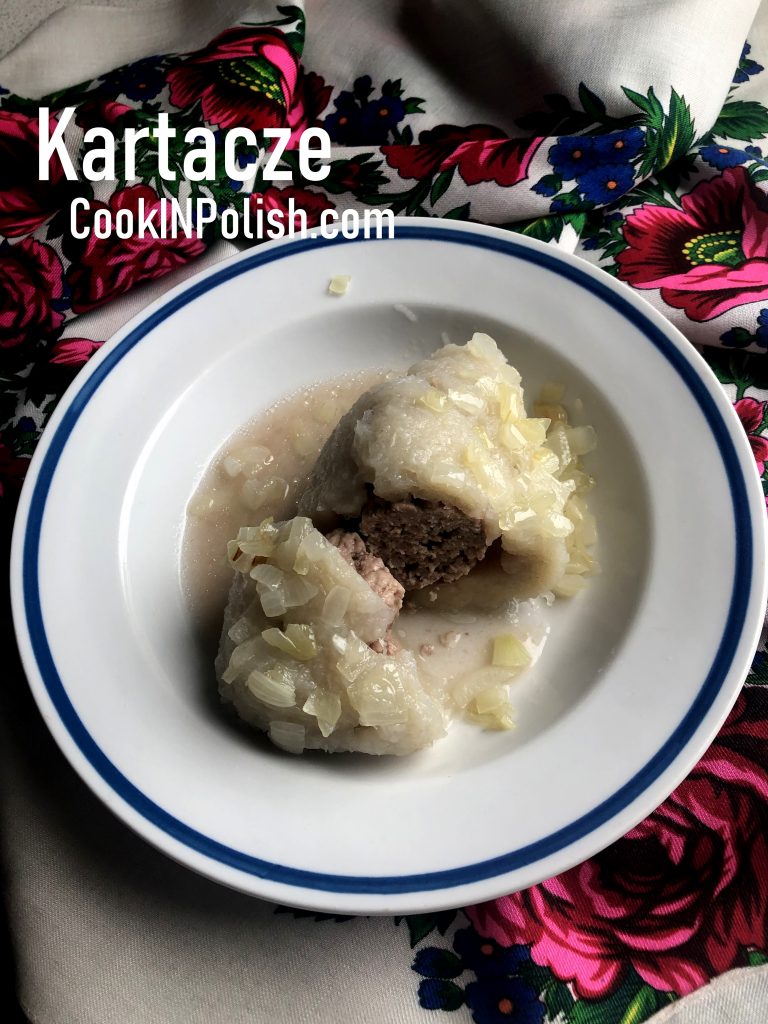 Kartacze Polish Potato Dumplings served on a plate with onions
