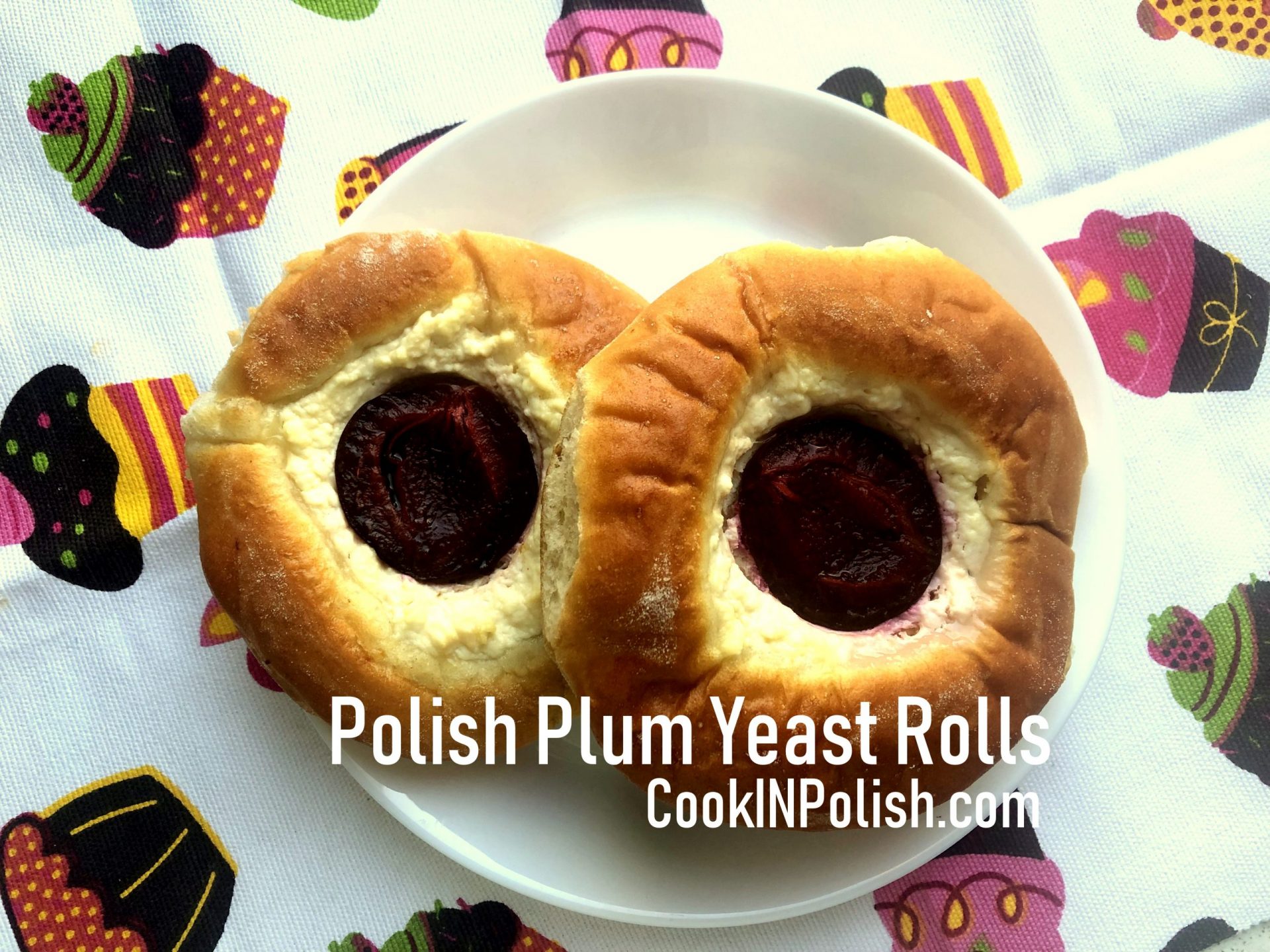 Polish Yeast Rolls with cheese and plums served on the plate.