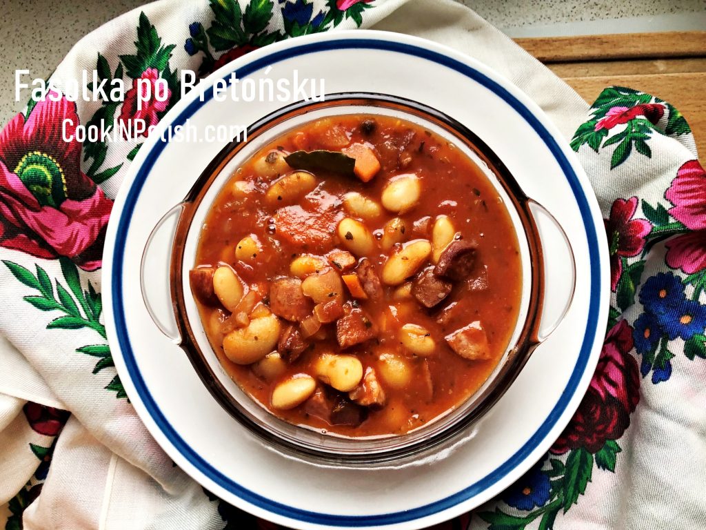 Polish baked beans with kiełbasa served in a bowl.