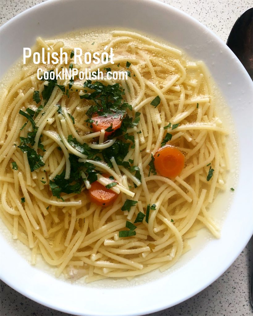 Polish Broth - Rosół served on the plate with parsley